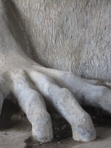 He waits beneath the bridge. Dark, with long arms.